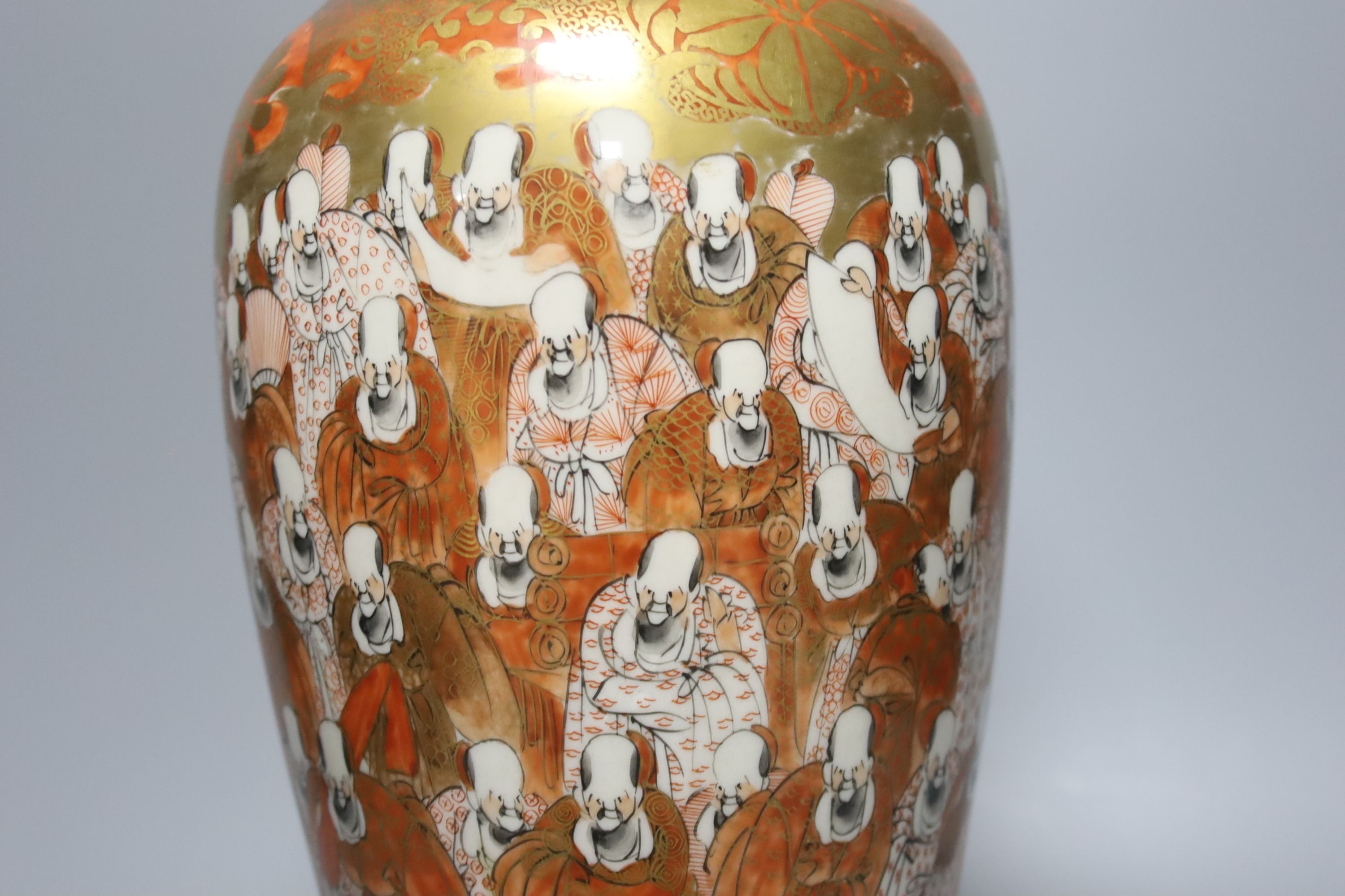 A tall Japanese Kutani porcelain vase, decorated with Rakan, 30cm, wood stand